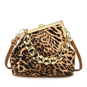 Vintage leopard shell handbag with gold chain and leather strap on white background