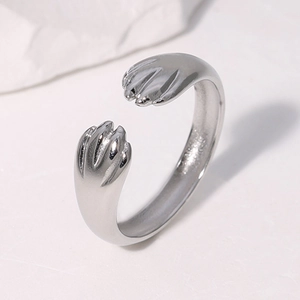 Silver stainless steel cat paw open ring with adjustable design on a stone base