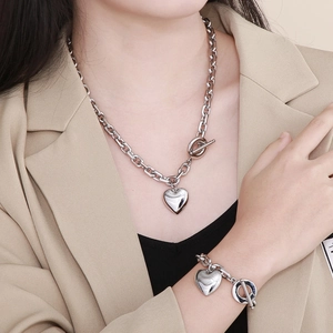 Detail of silver heart pendant necklace and bracelet set with OT toggle clasp