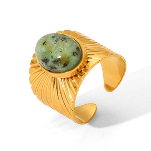 Vintage gold stainless steel ring with green tiger eye stone on white background