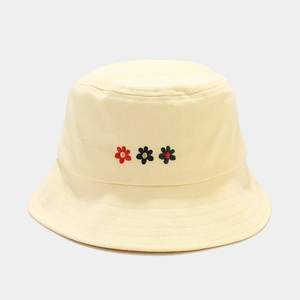 Detailed embroidery of small flowers on a beige cotton canvas sun hat for women