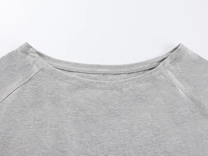 Close-up of the grey knit fabric neckline showing precise double-needle stitching details