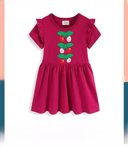 Detail of cherry embroidery and ruffled cap sleeves on a dark pink cotton girls' dress
