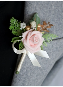 Detailed view of a pink PE foam rose boutonniere on a grey wool suit lapel for weddings