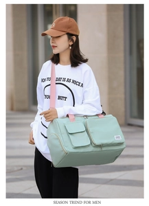 Detail of mint green gym bag with dedicated wet/dry separation and pink shoulder straps