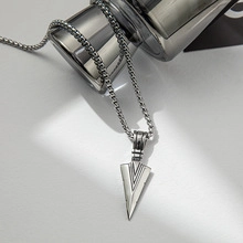 Detail of silver titanium steel snake chain with engraved arrowhead pendant and box chain