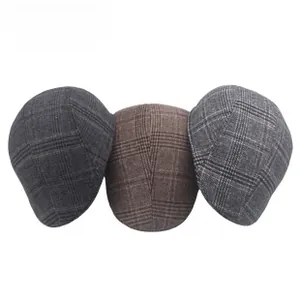 Detailed view of three wool textured newsboy caps featuring classic plaid patterns in grey and brown