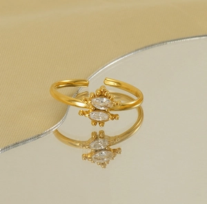 Macro detail of gold christmas tree ring featuring two marquise cut zircons with bead edges