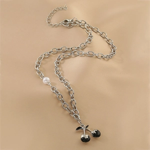Detail of silver chain necklace with black enamel cherry pendant and white pearl charm