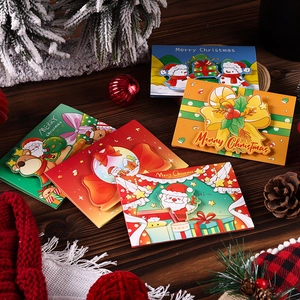 Detail of 3D Christmas cards with Santa and reindeer on a festive wooden surface