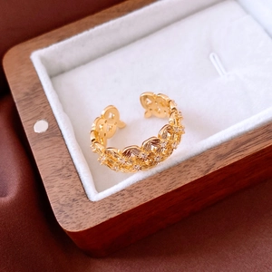 Detailed macro view of 18k gold plated hollow ring with diamonds in a wooden jewelry box
