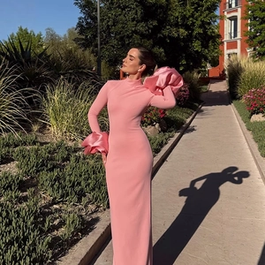 Elegantes rosa Maxikleid mit Stehkragen und dramatischen floralen Manschetten im Garten-Ambiente