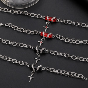 Gothic silver necklace featuring ruby and black gemstones with a cross pendant design