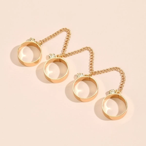 Detail of gold chain finger bracelet ring with star sequins and small clear crystals