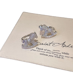 Minimalist silver rocking horse ear cuff set with pavé cubic zirconia on card background