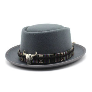 Detail of grey wool felt cowboy hat with ethnic ribbon and silver bull head ornament