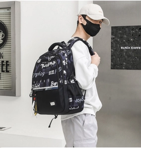 Close-up of black backpack with street graffiti prints and side mesh pocket detail