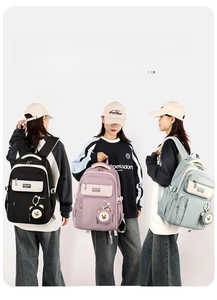 School backpacks in black, purple, and blue featuring cute bear charms and large capacity