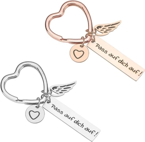 Detail of rose gold and silver heart keychains with German engraving and angel wings