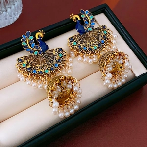 Vintage gold peacock jhumka earrings with blue enamel, tassels, and pearl bead drops