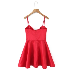 Detail view of red satin slip dress showing back invisible zipper and silky fabric texture