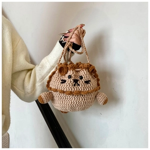 Close-up of handmade crochet lion bag showing detailed yarn texture and cartoon animal face