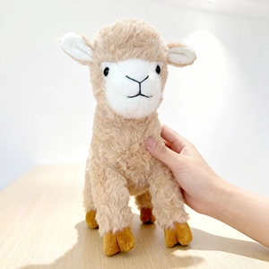 Cute beige alpaca plush toy with white face and soft fur held in hand for size