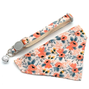 Close-up of floral pet collar and bandana set with silver bell and gray plastic buckle