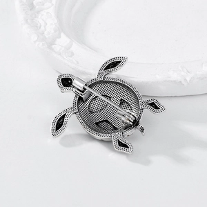 Vintage silver-plated turtle brooch back view showing textured metal and secure pin clasp