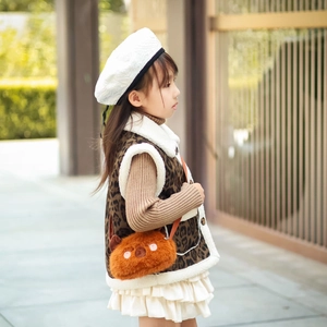 Cute plush animal crossbody bag for girls paired with a leopard print winter outfit