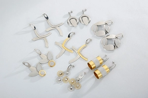 Flat lay of multiple trendy daisy and geometric metal earrings in gold and silver