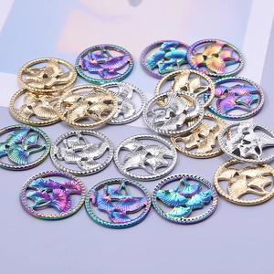 Detailed view of hollow ginkgo leaf charms in gold, silver and rainbow stainless steel