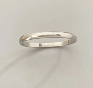 Macro shot of polished silver stainless steel minimalist band with smooth metallic finish