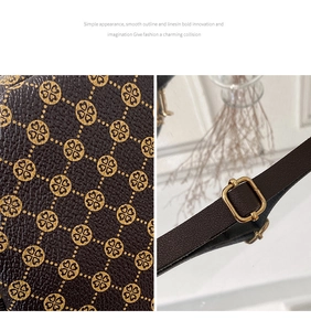 Detail of dark brown leather camera bag featuring golden clover print and metal strap buckle