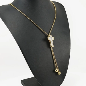 18K gold plated stainless steel cross pendant necklace with diamonds on black mannequin