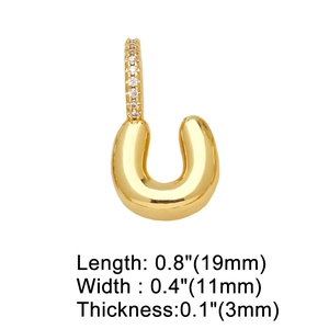 Macro shot showing dimensions of gold-plated horseshoe charm with inlaid zircons