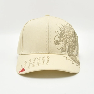 Beige baseball cap with dragon pattern and Chinese calligraphy in a frontal view
