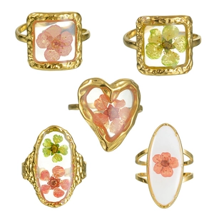 Minimalist resin rings with dried flowers in gold-tone heart and oval frames