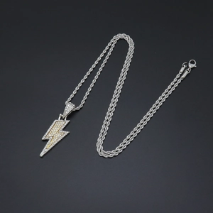 Macro shot of silver lightning pendant with crystal pavé and yellow stones on rope chain