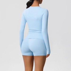 Rear view of light blue long-sleeve yoga top and high-waist shorts set for fitness