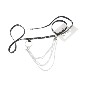 Detail of black faux leather body chain with silver eyelets and layered metal chains