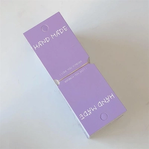 Detail view of purple handmade jewelry display cards with gold foil lettering