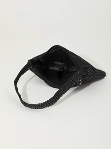 Macro detail of black rhinestone evening bag showing inner fabric lining and zipper closure