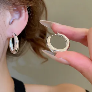 Irregular silver hoop earrings with a liquid metal texture in 18K gold plated style