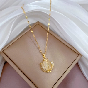 Close-up of golden tulip necklace with white cat eye stone and zircon flower petals