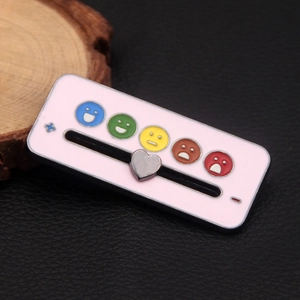 Detail view of pink mood tracker pin with sliding heart and colorful emoji icons