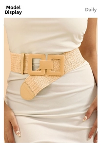 Detail of woven khaki straw waist belt with geometric square buckle on a white dress