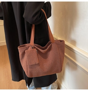Detail of caramel woven tote bag featuring soft textured fabric and matching coin purse