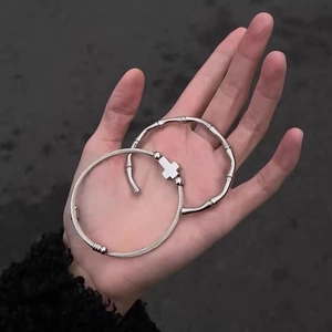 Vintage stainless steel bamboo and cross wire wrap bracelets worn on hand in silver
