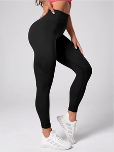 Detailed side view of high-waisted black seamless yoga pants with fine ribbed texture